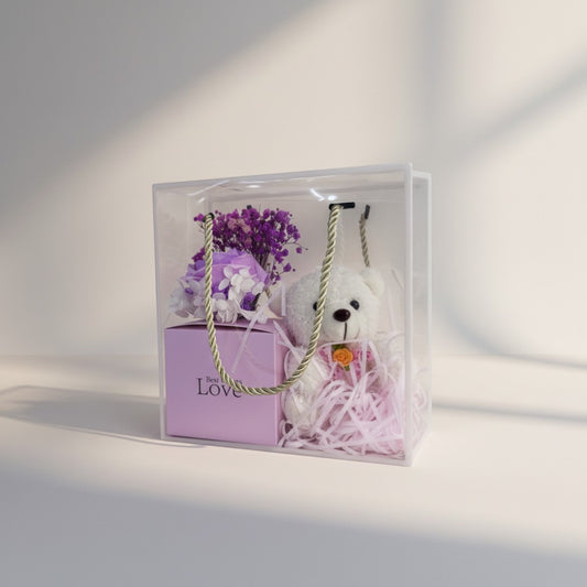 eRamis gift set with white teddy bear, purple dried flowers, and pink box with "Love" text.