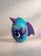 eRamis Monstercorn Surprise egg, teal with purple bat wings and horn, featuring a cute monster character.