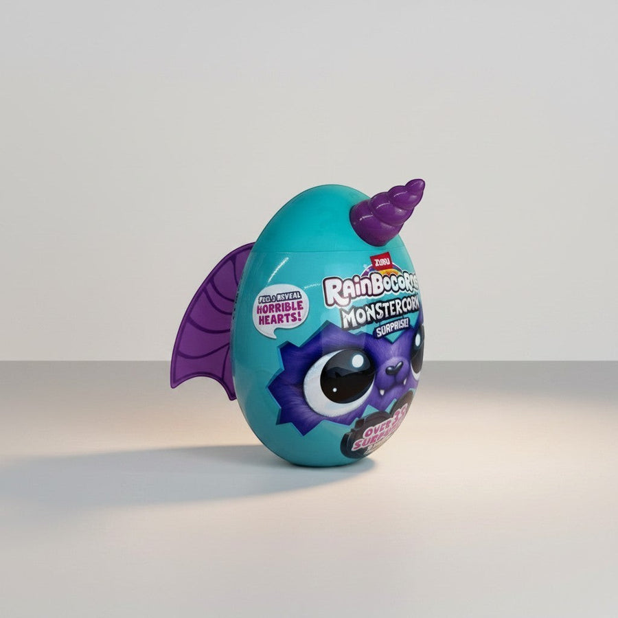 eRamis Monstercorn Surprise egg toy, teal with purple bat wings and horn, featuring a monster face.