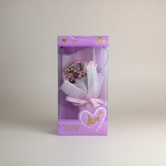 eRamis pink rose bouquet with small pink flowers, wrapped in white mesh and pink ribbon, in a purple box with hearts and the word "love".