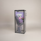 eRamis white plush teddy bear with pink heart saying "I Love You", next to a purple soap rose, in a clear box with ribbon.