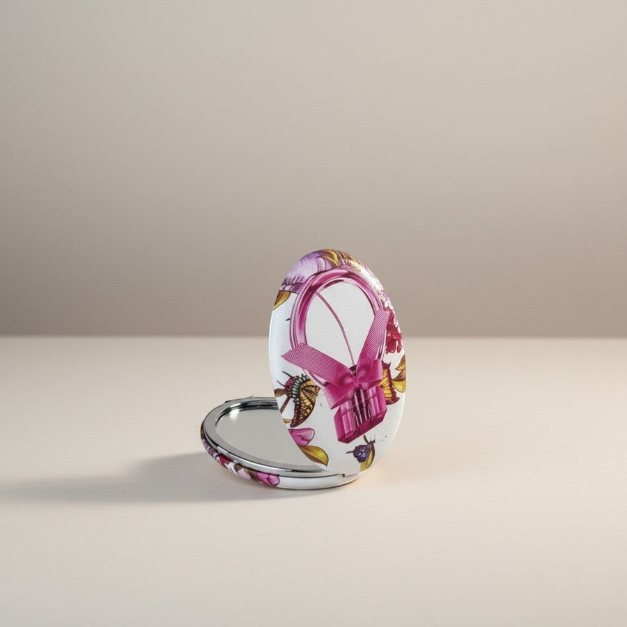 eRamis round compact mirror with floral and butterfly print, featuring a pink ribbon detail.