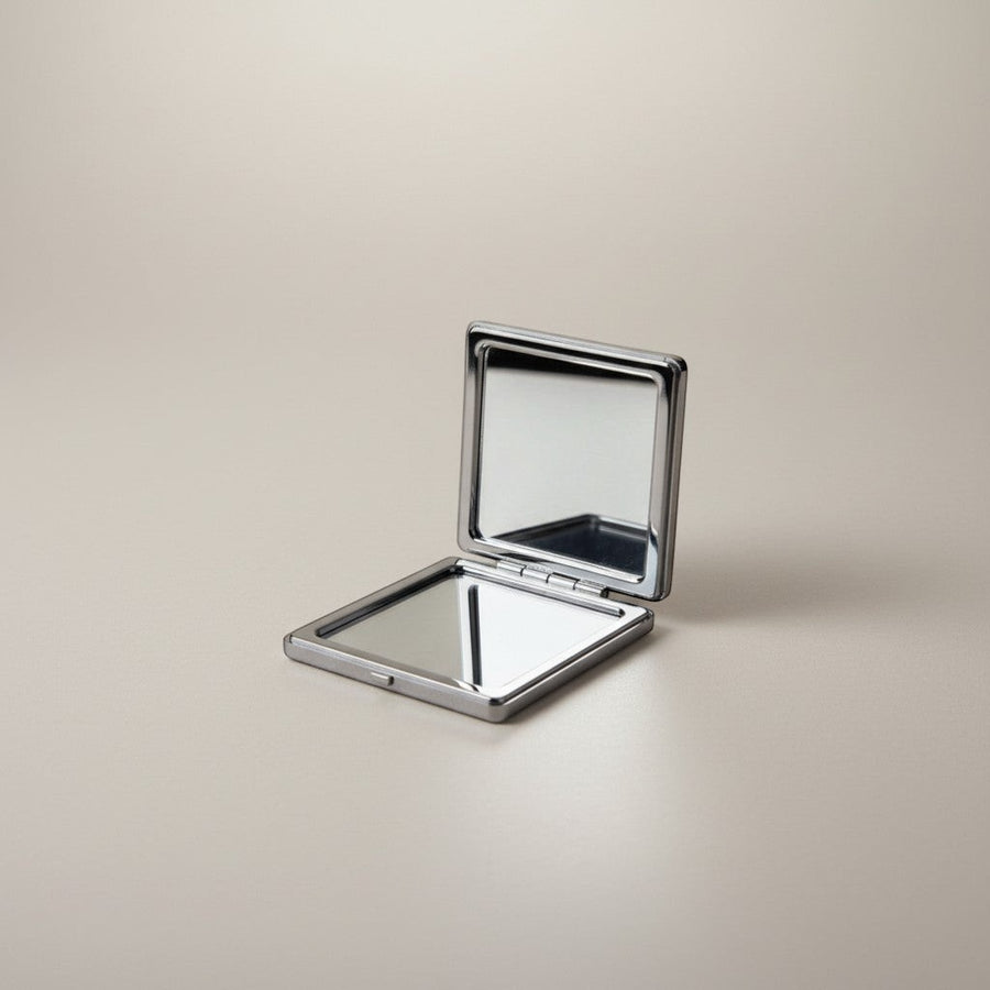 eRamis square compact mirror with a polished silver-tone metal frame and clear reflective surfaces.
