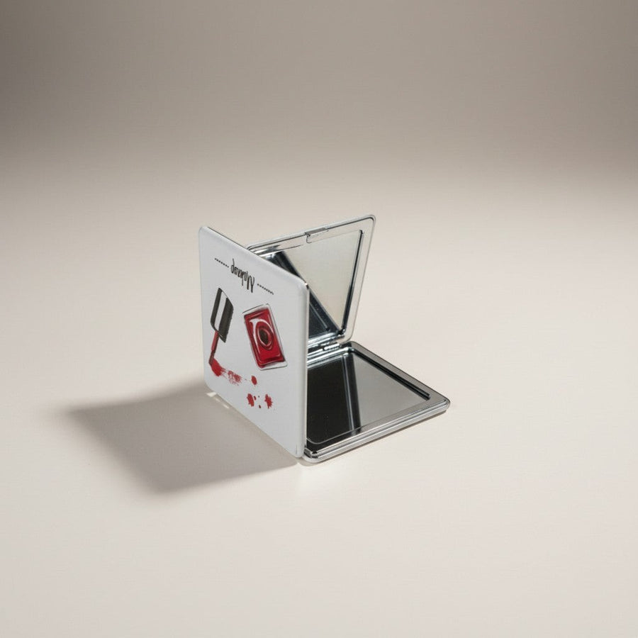 eRamis square makeup mirror with a red nail polish bottle design and silver trim. Compact and portable.