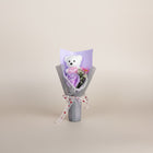 eRamis white plush teddy bear with pink heart, purple rose, and pink flowers in bouquet with pearl trim and heart ribbon.