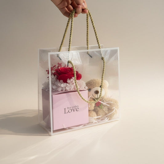 eRamis teddy bear and preserved red rose gift set in a clear gift bag with pink 'Best wishes Love' box.