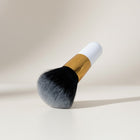 eRamis thick makeup brush with white handle, gold ferrule, and dense black to grey gradient bristles.