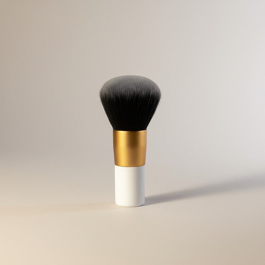 eRamis thick makeup brush with dense grey and black synthetic bristles and a white handle with a gold band.