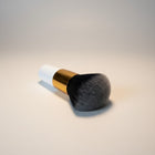 eRamis thick makeup brush with white handle, gold ferrule, and dense black and grey bristles.