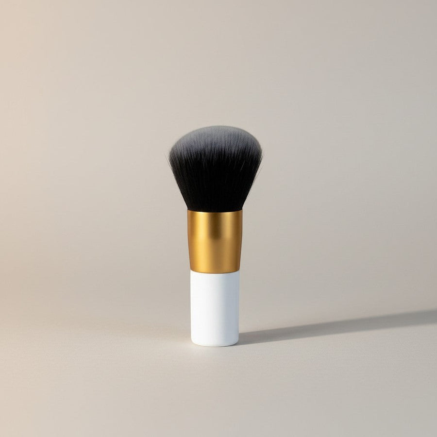 eRamis thick makeup brush with white handle, gold ferrule, and dense black and grey bristles.