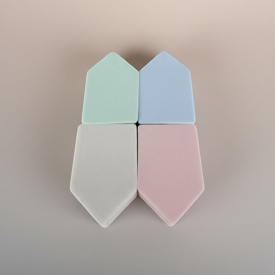 eRamis set of 4 triangular makeup sponges in pastel green, blue, grey, and pink.