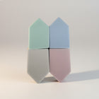 eRamis set of 4 triangular makeup sponges in pastel green, blue, grey, and pink.
