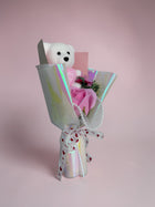 eRamis white teddy bear bouquet with pink soap roses, pearl accents, and a love-themed ribbon.