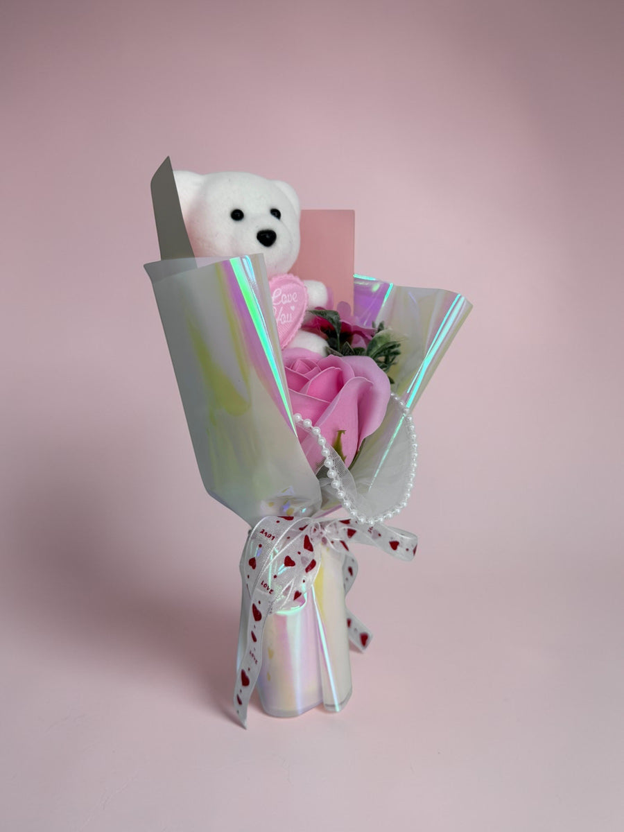eRamis white teddy bear bouquet with pink soap roses, pearl accents, and a love-themed ribbon.
