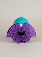 eRamisHere Monstercorn Surprise teal egg with purple bat wings and spiderweb design, featuring a black bat accent.
