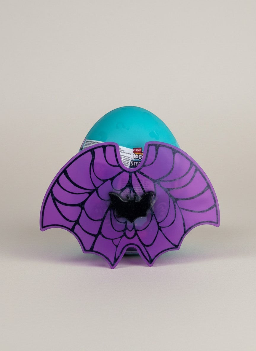 eRamisHere Monstercorn Surprise teal egg with purple bat wings and spiderweb design, featuring a black bat accent.