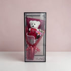 eRamisHere white teddy bear with red rose and pink flower bouquet in a clear box with red ribbon.