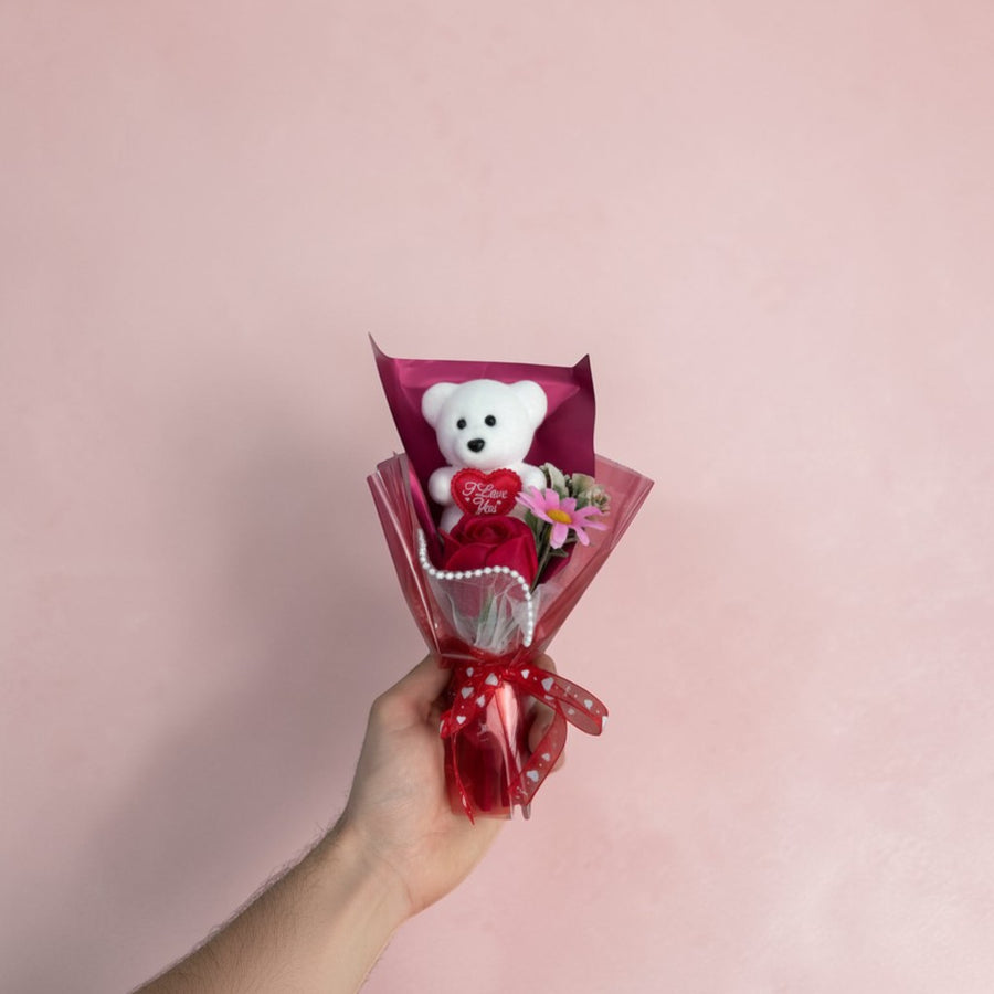eRamisHere white teddy bear with red rose and pink flower, gift-wrapped in red.