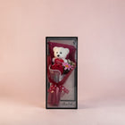 eRamisHere white teddy bear holding a red heart with 'I Love You' text, surrounded by red roses and pink flowers in a clear box.