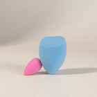 eRami set of 2 makeup sponges, one blue and one pink, with a rounded base and pointed tip.