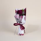 eRamis bouquet of red and pink roses with decorative heart wrapping and a 'love' ribbon.