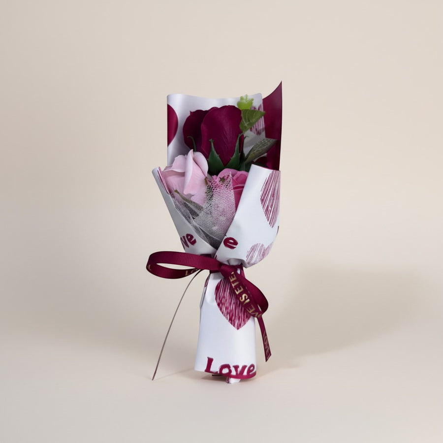eRamis bouquet of red and pink roses with decorative heart wrapping and a 'love' ribbon.