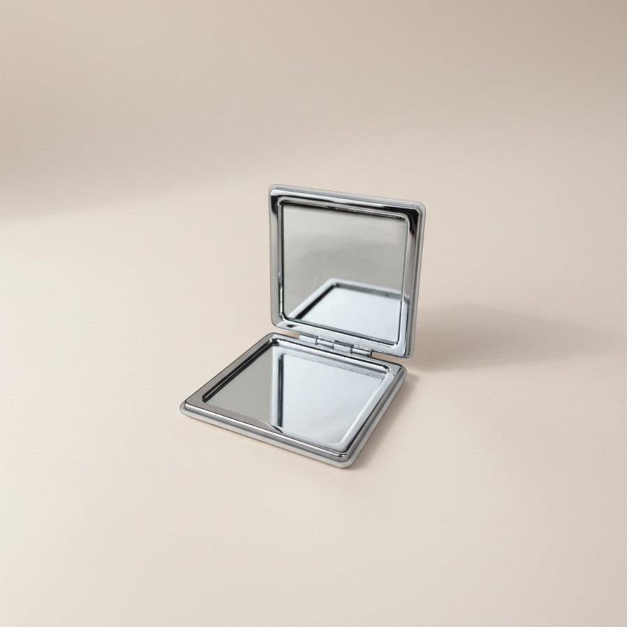 eRamis square compact makeup mirror with a silver metal frame and double-sided mirrors.