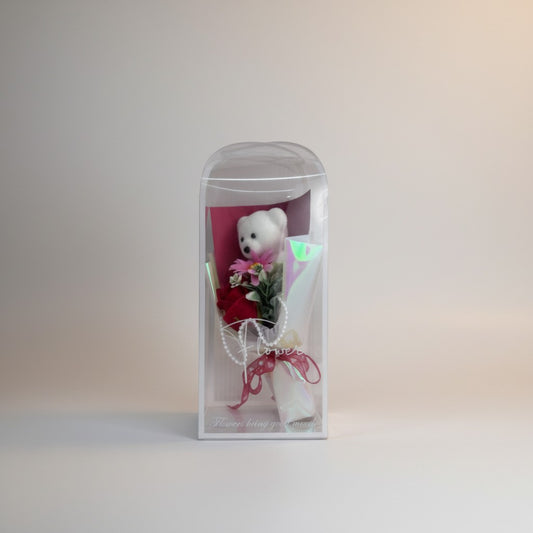 eRamis white teddy bear with red roses and pink flowers in a clear dome, accented with pearls and a red ribbon.